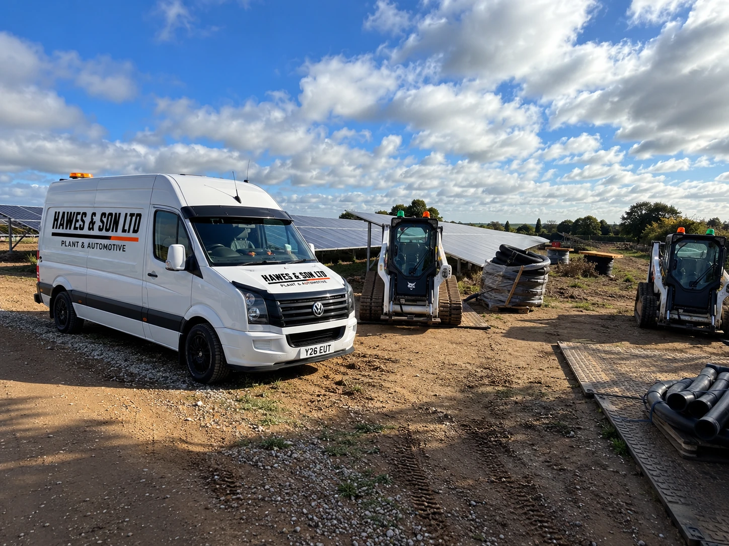 Hawes & Son Ltd branded service van alongside Bobcat machines at a solar farm worksite