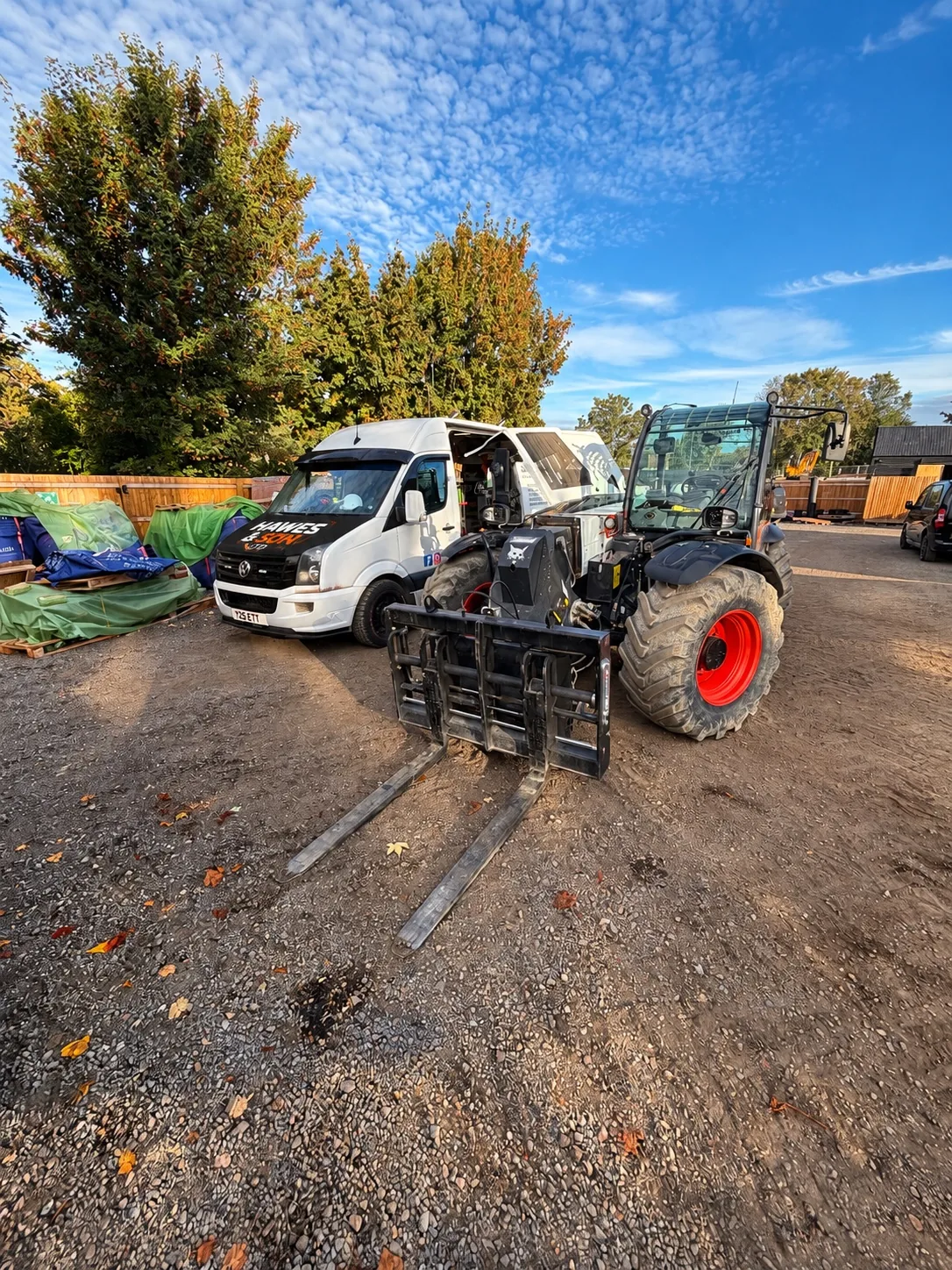 Bobcat telehandler and Hawes & Son service van at a customer site